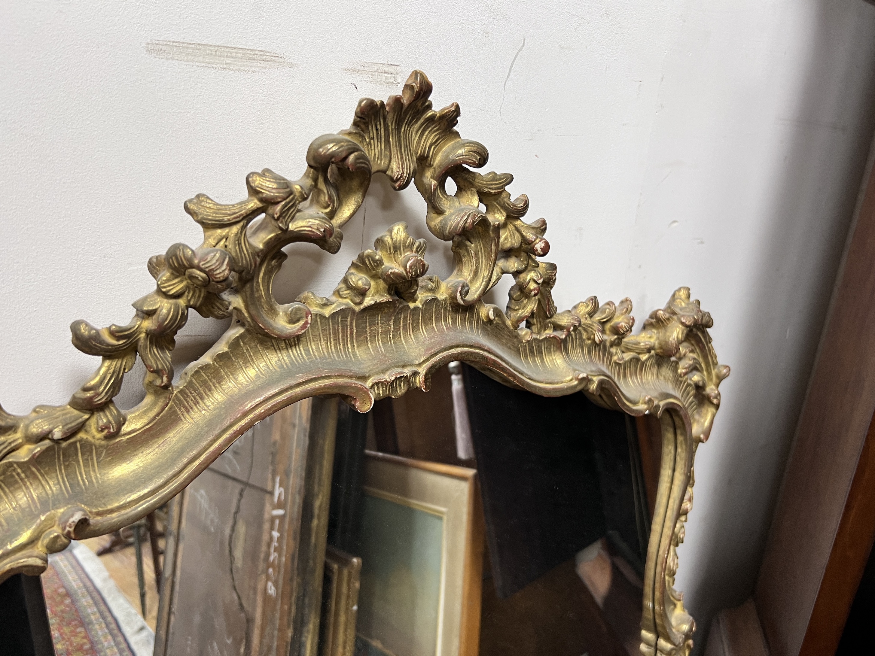 A Louis XVI style giltwood rococo framed wall mirror, height 116cm, width 84cm